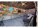 Unique outbuilding interior with rustic decor, lounge area, mounted TV, and eclectic wall art at 1125 Oceanview Rd, Charleston, SC 29412