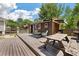Exterior of outbuilding showcasing a spacious deck with picnic table, seating, grill, and well-manicured backyard at 1125 Oceanview Rd, Charleston, SC 29412