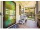 Inviting porch features a ceiling fan, stylish seating, and unique accents, perfect for relaxing at 1125 Oceanview Rd, Charleston, SC 29412