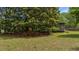 A spacious backyard featuring lush greenery and a screened-in porch, ideal for relaxation at 1129 Belvedere Ter, Mount Pleasant, SC 29464