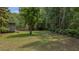 Expansive backyard featuring mature trees providing shade and privacy on the property at 1129 Belvedere Ter, Mount Pleasant, SC 29464
