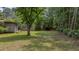 A view of the expansive backyard and screened porch with trees and greenery at 1129 Belvedere Ter, Mount Pleasant, SC 29464