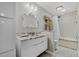 Bright bathroom featuring dual sinks, marble countertop, framed mirror, and tub shower at 1129 Belvedere Ter, Mount Pleasant, SC 29464