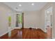 Sunlit bedroom with hardwood floors and doors leading to an outdoor space at 1129 Belvedere Ter, Mount Pleasant, SC 29464
