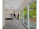 Versatile bonus room with treadmill, views, and access to the outdoors via sliding glass doors at 1129 Belvedere Ter, Mount Pleasant, SC 29464