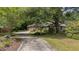 Charming single-story home with lush landscaping, mature trees, and a welcoming driveway at 1129 Belvedere Ter, Mount Pleasant, SC 29464