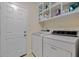 Functional laundry room with a washer, dryer and storage shelving located next to the doorway at 1129 Belvedere Ter, Mount Pleasant, SC 29464