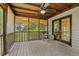 Inviting screened porch with wooden ceiling, ceiling fan, and tranquil view of nature at 1129 Belvedere Ter, Mount Pleasant, SC 29464