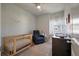 Bright Bedroom with detailed wallpaper, crib, comfortable chair, and changing table near a window providing natural light at 114 Rowans Creek Dr, Charleston, SC 29492