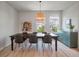 Dining room with view to the outside features a table with seating for six, a modern light fixture, and a blue cabinet at 114 Rowans Creek Dr, Charleston, SC 29492