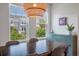 A wooden table and chairs are set near a window, next to a built-in blue cabinet and a modern light fixture at 114 Rowans Creek Dr, Charleston, SC 29492