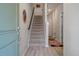 Inviting foyer with hardwood floors, staircase, and a decorative mirror that enhances the home's entrance appeal at 114 Rowans Creek Dr, Charleston, SC 29492