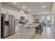 Modern kitchen with stainless steel appliances, a marble countertop island, and an open view to the dining area at 114 Rowans Creek Dr, Charleston, SC 29492