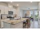 Modern kitchen with stainless steel appliances, a marble island with seating, and an open layout for easy entertaining at 114 Rowans Creek Dr, Charleston, SC 29492