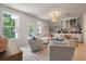 Bright living room with built-in bookshelves, light wood floors, and comfortable seating at 114 Rowans Creek Dr, Charleston, SC 29492