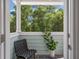 Cozy screened porch featuring a comfortable chair, a potted plant, and a relaxing view of lush greenery at 114 Rowans Creek Dr, Charleston, SC 29492