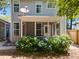 A charming backyard with a screened-in porch and vibrant blue hydrangeas blooming in the garden at 1199 Landau Ln, Mount Pleasant, SC 29466