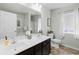 Bathroom featuring double sinks, vanity, toilet, window and access to a bathtub/shower combo at 1199 Landau Ln, Mount Pleasant, SC 29466