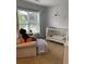 Well-lit bedroom featuring a crib, a chair with soft cushions and plush toys near a large window at 1199 Landau Ln, Mount Pleasant, SC 29466