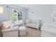 Bright Bedroom with a crib, glider and a large window allowing for natural light at 1199 Landau Ln, Mount Pleasant, SC 29466