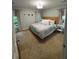 A spacious bedroom features a king bed with soft, neutral-toned bedding, light-colored walls, and natural light from two windows at 1199 Landau Ln, Mount Pleasant, SC 29466