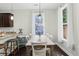 Sun-filled dining area features a rustic table with seating for six and modern pendant lighting at 1199 Landau Ln, Mount Pleasant, SC 29466