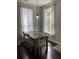 Bright dining room with a wooden table, white chairs, and modern lighting at 1199 Landau Ln, Mount Pleasant, SC 29466