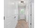 Neutral hallway with carpet, multiple doors, and overhead lighting, leading to other areas of the home at 1199 Landau Ln, Mount Pleasant, SC 29466
