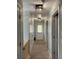 Well-lit hallway with carpet, white doors, and modern light fixtures at 1199 Landau Ln, Mount Pleasant, SC 29466