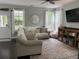 Comfortable living room with large windows, plush sofa, and contemporary decor at 1199 Landau Ln, Mount Pleasant, SC 29466