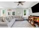 Inviting living room features a comfortable sectional sofa, ceiling fan, and natural light from large windows at 1199 Landau Ln, Mount Pleasant, SC 29466