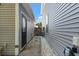 Narrow side yard featuring stone pavers and access to the front and back yards at 1199 Landau Ln, Mount Pleasant, SC 29466