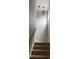 Carpeted staircase with a wooden handrail and modern light fixture at 1199 Landau Ln, Mount Pleasant, SC 29466