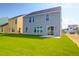 A large backyard with a grassy area, perfect for outdoor activities with patio and a view of the home at 1215 Homecoming Blvd # Cc2-1-25, Ravenel, SC 29470