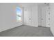 This bedroom features neutral carpet, white walls, window, and two doors at 1215 Homecoming Blvd # Cc2-1-25, Ravenel, SC 29470