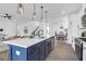 Open kitchen featuring an island with pendant lights, modern appliances, and hardwood flooring at 1215 Homecoming Blvd # Cc2-1-25, Ravenel, SC 29470