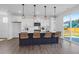 Stylish kitchen with an island, pendant lighting, and seamless access to outdoor space at 1215 Homecoming Blvd # Cc2-1-25, Ravenel, SC 29470