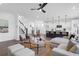 Inviting living room featuring a modern kitchen with a breakfast bar, cozy seating area, and stylish staircase at 1215 Homecoming Blvd # Cc2-1-25, Ravenel, SC 29470