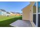 Concrete patio and grass backyard; house has many windows at 1217 Homecoming Blvd # Cc2-1-26, Ravenel, SC 29470