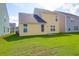 Lush green backyard featuring a yellow home exterior on a sunny day at 1217 Homecoming Blvd # Cc2-1-26, Ravenel, SC 29470