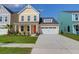 Charming yellow two-story home with a well-maintained lawn, white garage door, and bright orange front door at 1217 Homecoming Blvd # Cc2-1-26, Ravenel, SC 29470