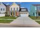 Beautiful yellow two-story home with a manicured lawn, white garage door, and bright orange front door at 1217 Homecoming Blvd # Cc2-1-26, Ravenel, SC 29470