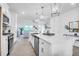 Bright kitchen with white cabinets, a large island, modern appliances, and open view to the living area at 1217 Homecoming Blvd # Cc2-1-26, Ravenel, SC 29470