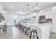 Bright white kitchen features a large island with barstool seating and modern pendant lighting above at 1217 Homecoming Blvd # Cc2-1-26, Ravenel, SC 29470