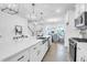 Bright, open kitchen with a large island, stainless steel appliances, modern lighting, and an adjacent dining area at 1217 Homecoming Blvd # Cc2-1-26, Ravenel, SC 29470
