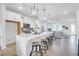Beautiful bright kitchen with white cabinets, a large island, and an open view to the living area at 1217 Homecoming Blvd # Cc2-1-26, Ravenel, SC 29470