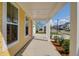 Inviting yellow porch with white columns, manicured landscaping, and view of the neighborhood at 1217 Homecoming Blvd # Cc2-1-26, Ravenel, SC 29470