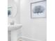 Bright powder room with a pedestal sink, round mirror, and coastal-inspired art creating a serene atmosphere at 1217 Homecoming Blvd # Cc2-1-26, Ravenel, SC 29470