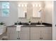 Modern bathroom featuring double sinks, granite countertops, and stylish fixtures at 1224 Midvale Ave, Charleston, SC 29412