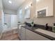 Bright bathroom with double vanity, sleek countertops, modern fixtures, and stylish shower with a glass door at 1224 Midvale Ave, Charleston, SC 29412